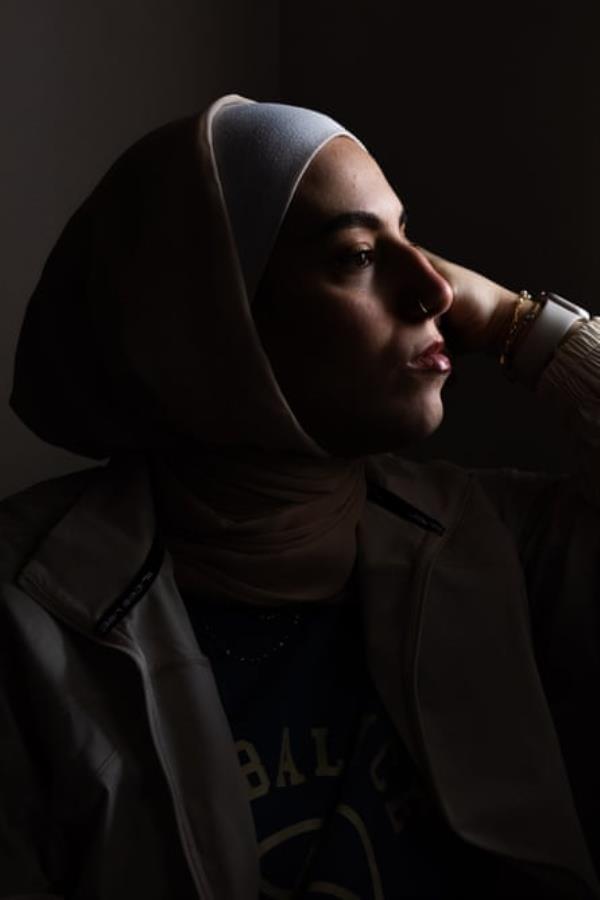 Profile view of woman with black background