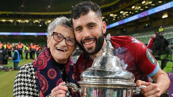 Dave Webster and his grandmother Rita celebrate with the FAI Cup trophy